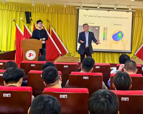 A person standing in front of a podium with a crowd of people in the background
Description automatically generated